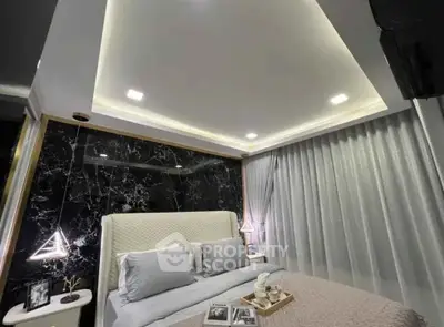 Luxurious modern bedroom with elegant lighting and marble accent wall