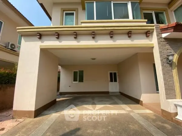 Spacious covered parking area in modern residential property with elegant architectural design.