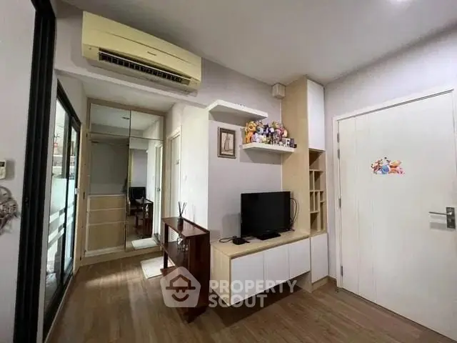 Cozy living room with modern decor and air conditioning in a stylish apartment.
