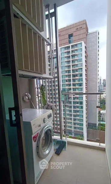 Modern apartment balcony with washing machine and city view