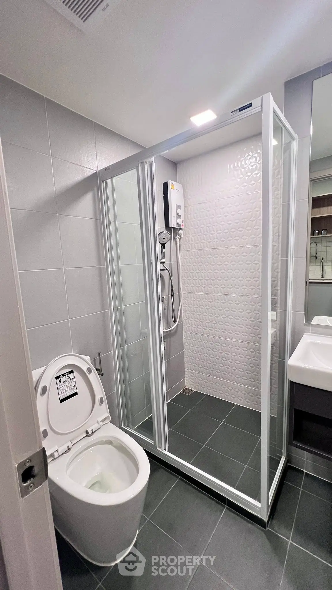 Modern bathroom with sleek shower enclosure and contemporary fixtures.