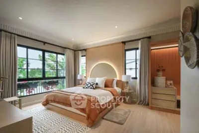 Luxurious bedroom with modern decor and large windows offering a serene garden view.