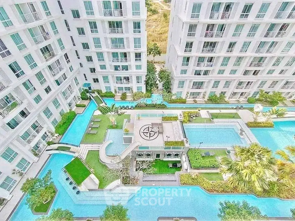 Luxurious condominium complex with stunning pool and lush gardens, offering a serene urban oasis.