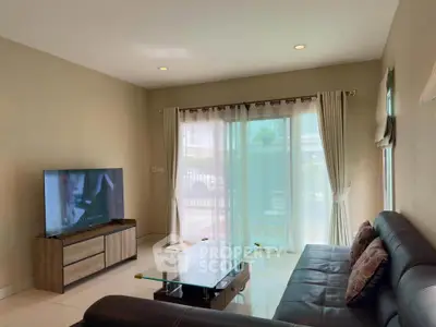 Spacious living room with modern decor and large window for natural light.