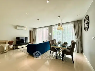 Spacious modern living room with elegant dining area and large windows.