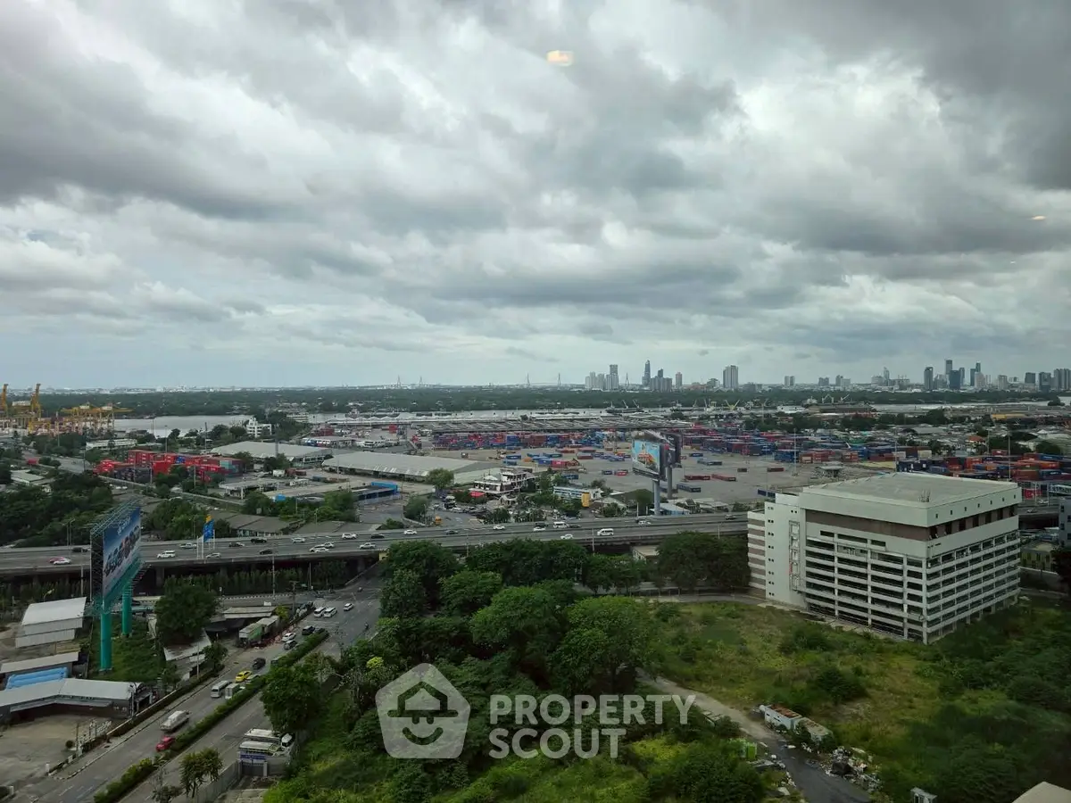 Stunning cityscape view from high-rise building with lush greenery and urban skyline.