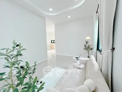 Elegant living room with modern decor and cozy seating area, perfect for relaxation.