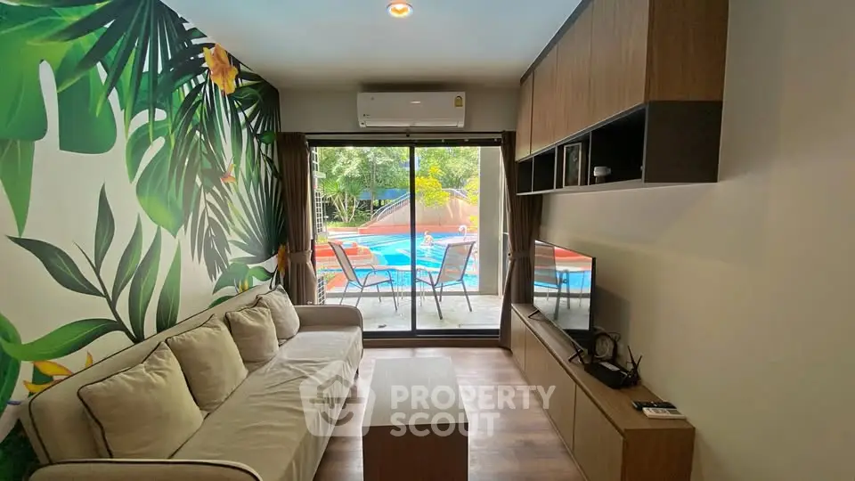 Stylish living room with pool view, tropical decor, and modern furnishings for a serene lifestyle.