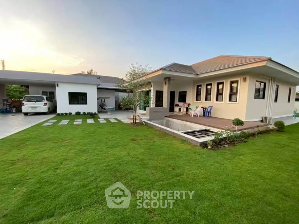Charming modern home with lush green lawn and spacious driveway, perfect for family living.