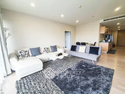 Spacious modern living room with stylish decor and open kitchen layout