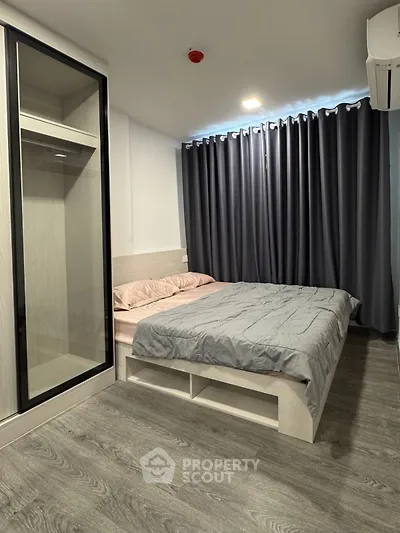 Modern bedroom with sleek design, featuring a cozy bed and stylish wardrobe.