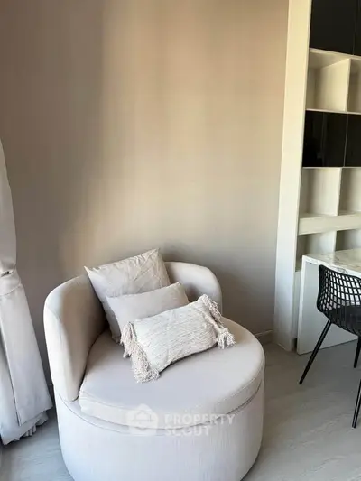 Cozy modern living room corner with stylish round chair and sleek desk, perfect for relaxation and work.
