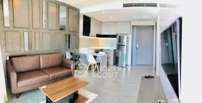 Modern open-layout living room with sleek kitchen and stylish furniture in a contemporary apartment.