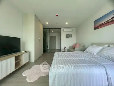 Spacious modern bedroom with cozy decor and large bed in a stylish apartment.