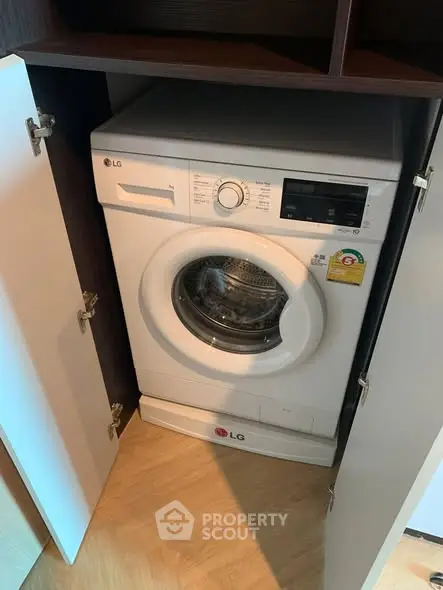 Modern apartment with built-in LG washing machine in sleek cabinetry.