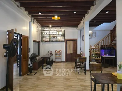 Charming open-layout living space with wooden accents and modern lighting.