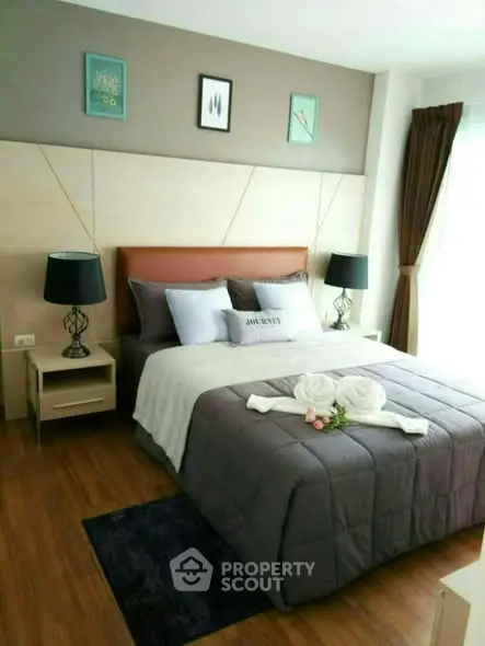 Elegant bedroom with modern decor and cozy bedding in a stylish apartment.