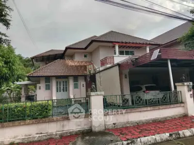 Charming suburban house with tiled roof and carport in a peaceful neighborhood.