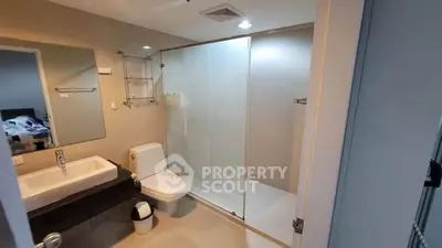 Modern bathroom with glass shower and sleek fixtures