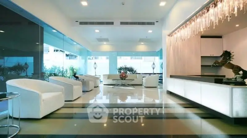 Luxurious modern living room with elegant decor and panoramic glass windows.