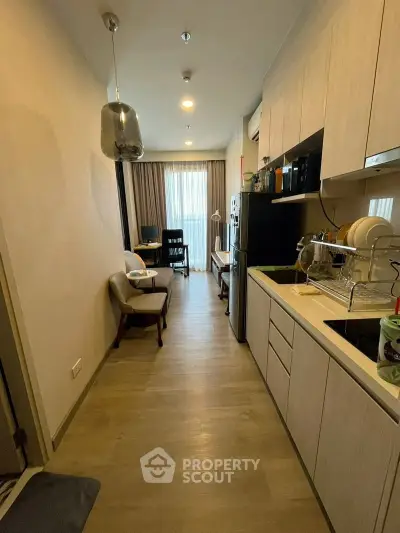 Modern kitchen with open layout and cozy living area in stylish apartment