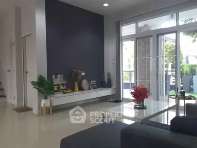 Spacious modern living room with large windows and stylish decor