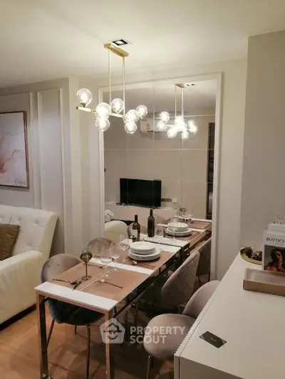 Elegant dining area with modern chandelier and stylish decor in a cozy living space.