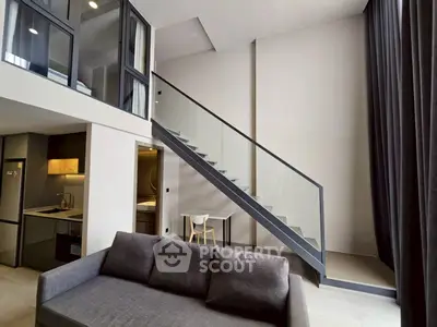 Modern loft apartment with sleek staircase and open kitchen layout