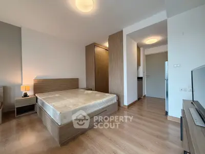 Modern bedroom with wooden flooring and stylish furniture