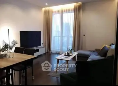 Modern living room with stylish decor and large TV, perfect for relaxation.