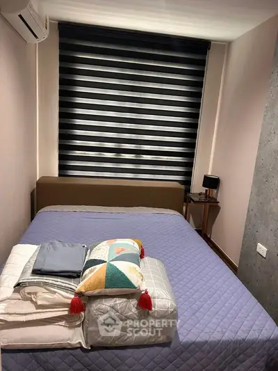 Cozy bedroom with modern decor and stylish window blinds, perfect for restful nights.