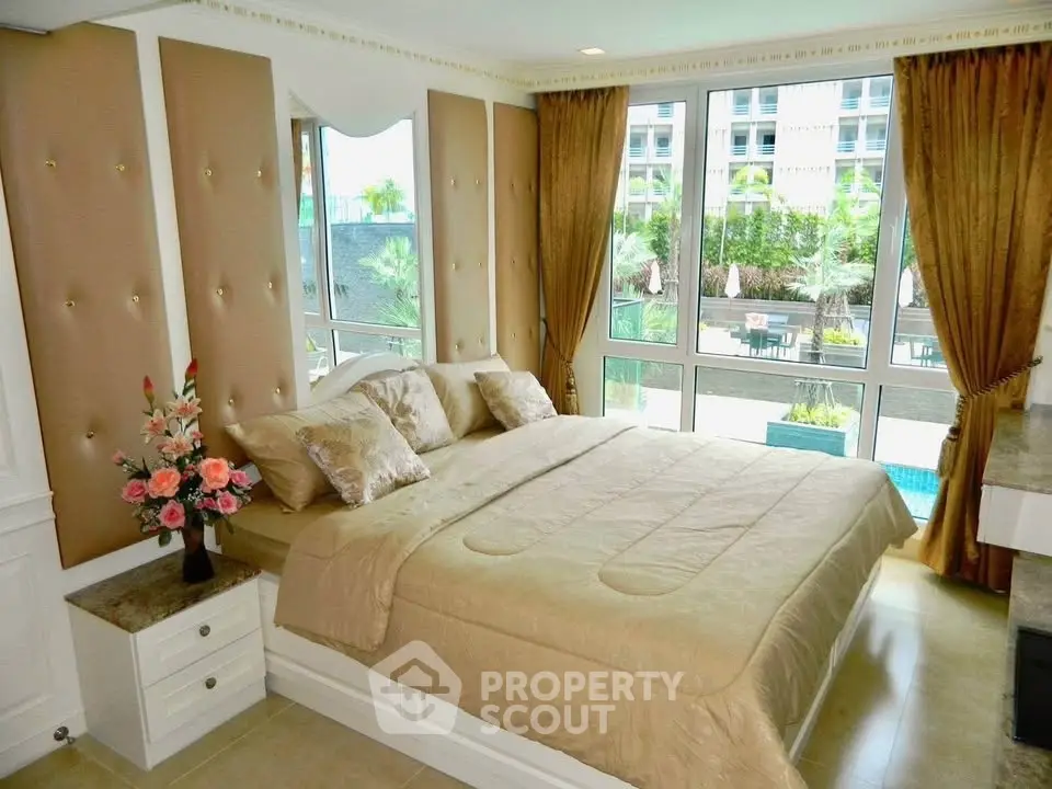 Luxurious bedroom with elegant decor and pool view, perfect for relaxation.