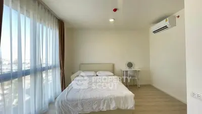 Bright and airy bedroom with large windows and modern furnishings in a minimalist style.