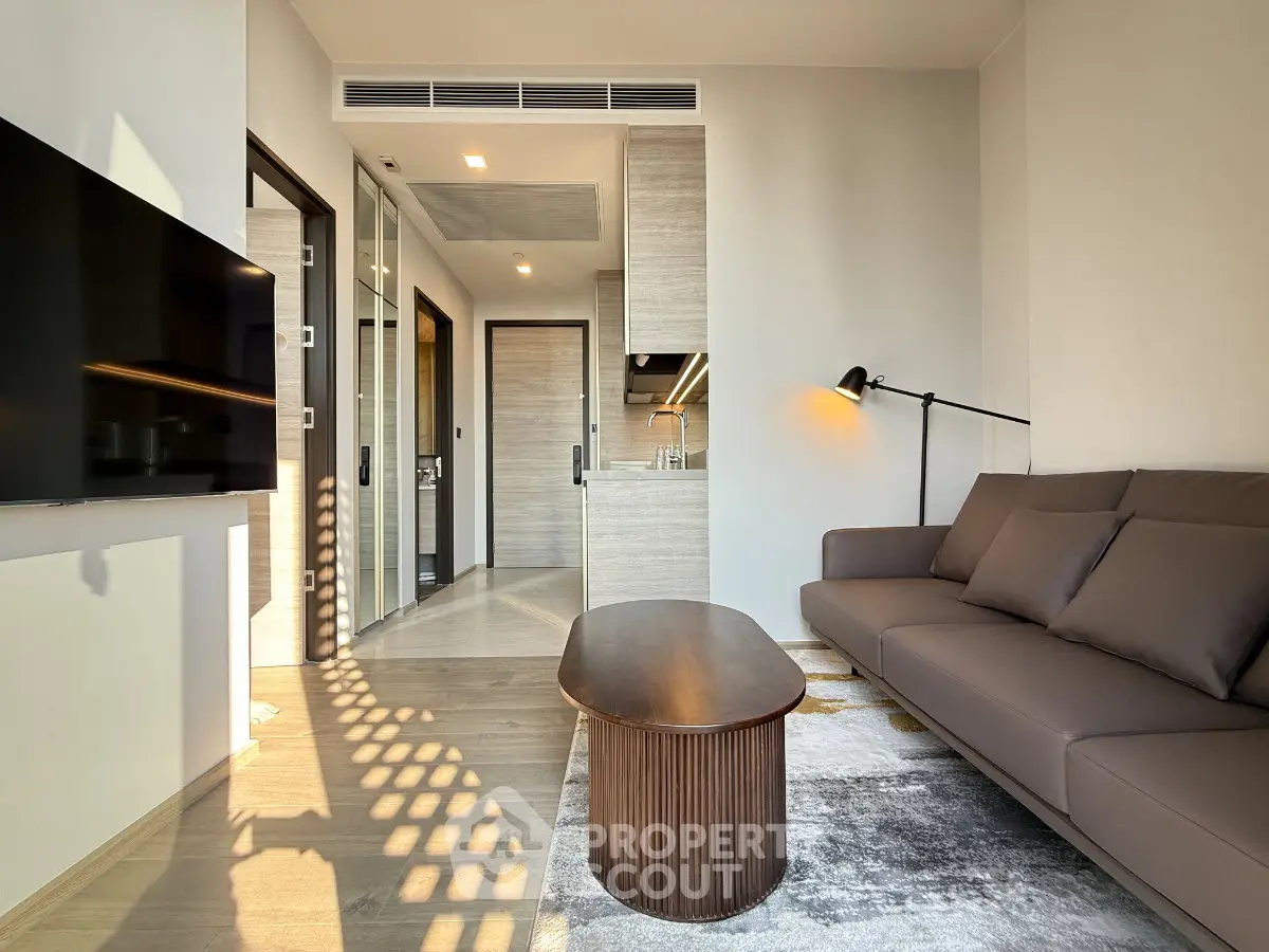 Modern living room with sleek furniture and open kitchen layout, perfect for contemporary urban living.