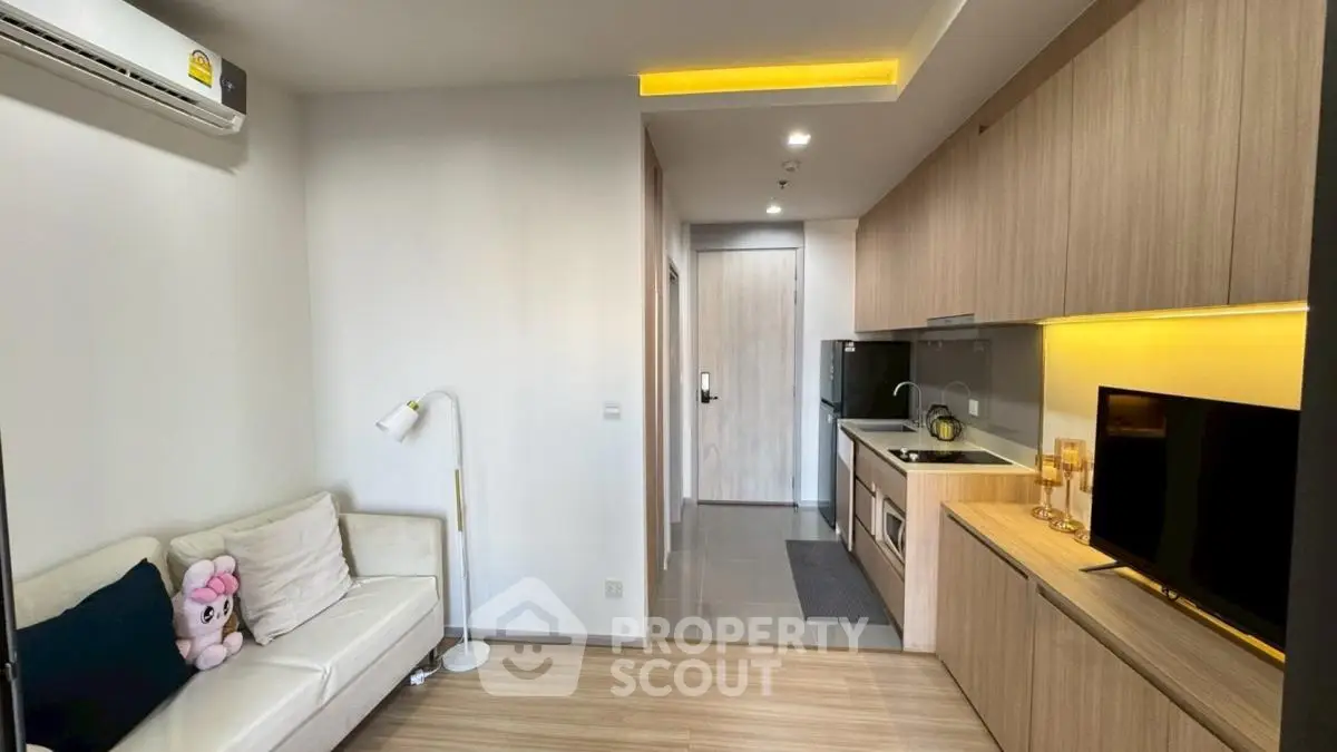 Modern studio apartment with cozy living area and sleek kitchen design.