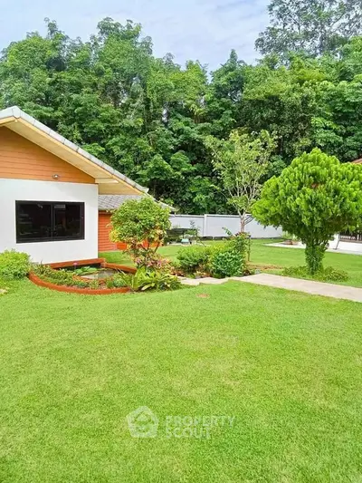 Charming suburban home with lush green garden and manicured lawn, perfect for outdoor relaxation.