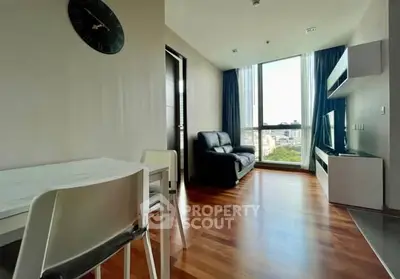 Modern living room with wooden flooring and large window view