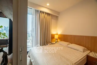 Modern bedroom with city view and balcony access, featuring cozy lighting and elegant decor.