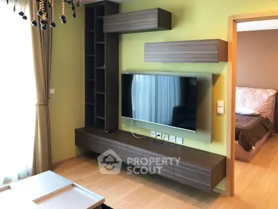 Modern living room with stylish TV unit and cozy bedroom view, perfect for contemporary living.