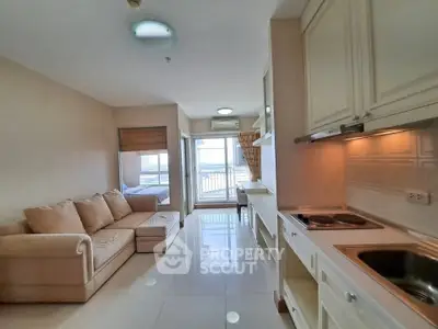 Modern open-plan living room with kitchen and balcony view