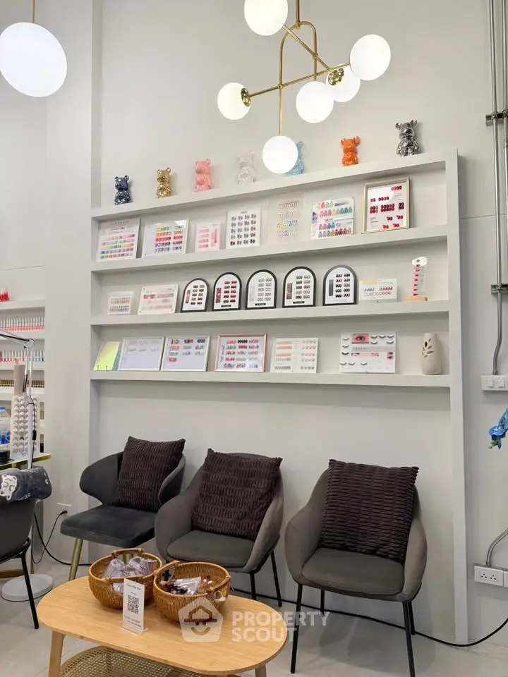 Chic modern interior with stylish seating and decorative wall shelves in a cozy lounge area.