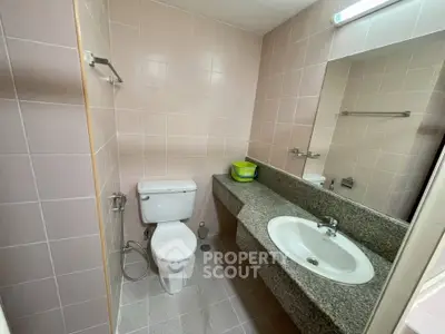Compact bathroom with modern fixtures and granite countertop in a cozy real estate property.