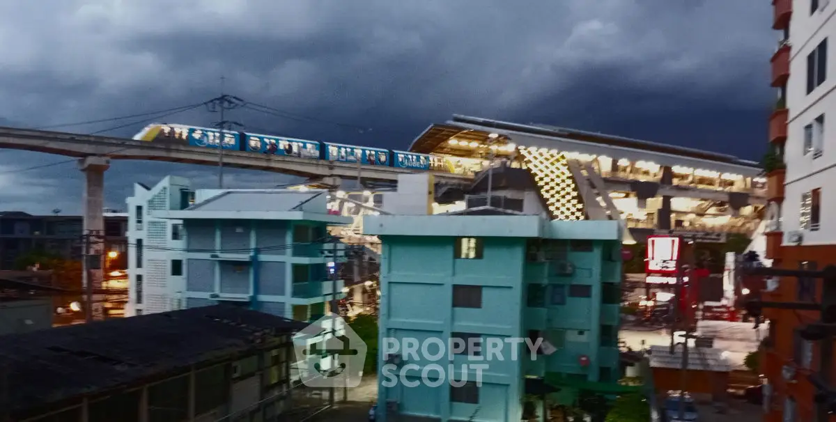 Urban cityscape with modern train station and residential buildings at dusk