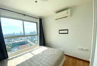 Bright bedroom with city view, featuring a large window and air conditioning unit.