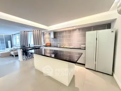 Spacious modern kitchen with island and open layout in luxury apartment