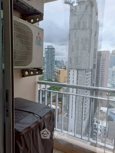 High-rise balcony with city view and air conditioning unit, perfect urban living.