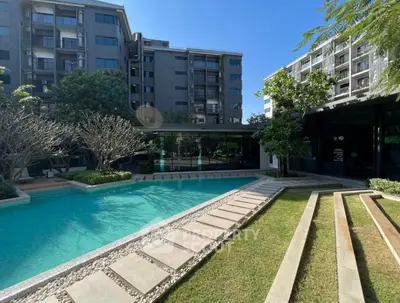 Luxurious residential complex with a stunning outdoor pool and landscaped garden.