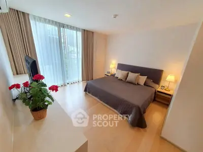 Spacious modern bedroom with large windows and elegant decor