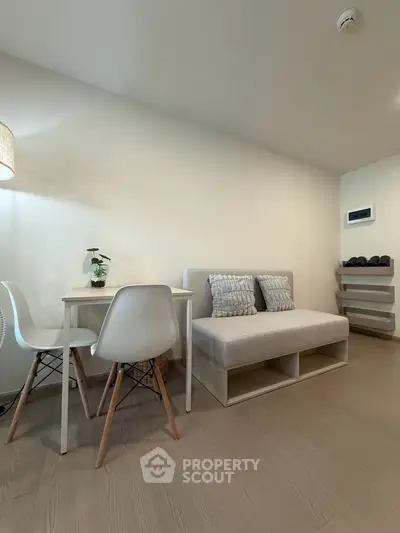 Modern living room with cozy sofa and dining area in minimalist style