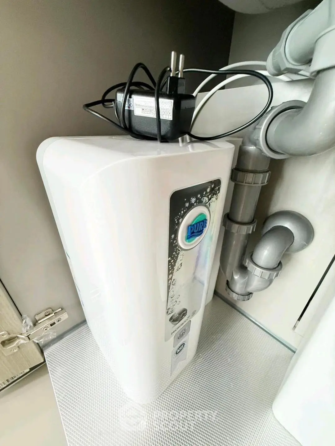 Modern water filtration system installed under kitchen sink